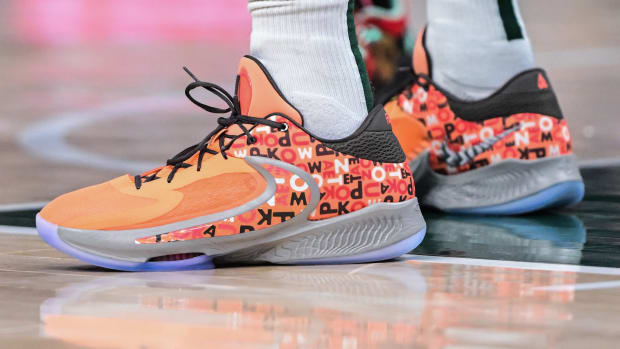 View of Giannis Antetokounmpo's orange and black Nike shoes.
